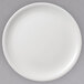 A white Villeroy & Boch porcelain plate with a white rim on a gray surface.