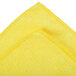 A yellow microfiber cloth with white stitching.