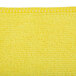 A yellow Unger SmartColor microfiber cleaning cloth with a small hole in it.