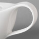 A close up of a white Villeroy & Boch porcelain teapot with a handle.
