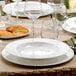 A table set with Villeroy & Boch white bone porcelain plates and glasses.