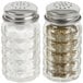 Two Tablecraft glass salt and pepper shakers with stainless steel tops.
