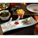 A Villeroy & Boch rectangular porcelain plate with food on a table.