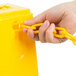 A hand holding a yellow plastic chain.