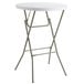 A Lancaster Table & Seating white round heavy-duty plastic folding table with a metal frame.