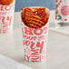 A Choice paper cup with a hot food print filled with waffles.