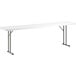 A white rectangular Lancaster Table & Seating plastic folding table with metal legs.