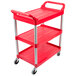 A red Rubbermaid plastic three shelf utility cart with silver handles and wheels.