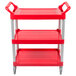 A red Rubbermaid plastic utility cart with three shelves and wheels.