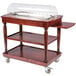 A Bon Chef mahogany cheese cart with a clear cover.