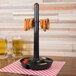 A black charcoal polypropylene combo server holding food on a table.