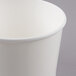 A close-up of a white Choice paper cup.