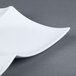 A CAC white porcelain divided tasting plate with a white design.