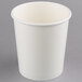 A white paper food cup with a lid on a gray surface.