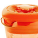 A Waring orange plastic blender jar with a lid.