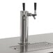 An Avantco black beer dispenser with two silver beer taps on a counter.