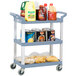 A Vollrath gray utility cart with three shelves holding food and drinks.