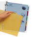 A hand using Avery Index Maker 5-tab plastic dividers to organize a yellow file folder.
