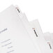 A set of white Avery Index Maker plastic dividers with clear labels on white folders.