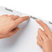 Two hands pointing at Avery white divider labels on a file folder.