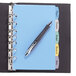 A pen on a blue Avery 5-Tab Write-On Plastic Divider sitting on a notebook.