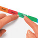 A person using a finger to point at a colorful Avery Index Maker tab on a piece of paper.