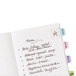 Avery Ultra Tabs in assorted pastel colors with a list of food in a notebook.