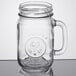 A Libbey County Fair glass jar with a handle.