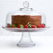 A chocolate cake with strawberries on top of an Anchor Hocking glass cake stand.