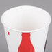 A white Solo paper cold cup with a red and black Coca Cola logo.