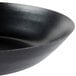 A close-up of a black Town 9" carbon steel fry pan with a black rim.