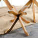 A Tablecraft acacia wood riser set with three fold-away wooden legs.