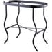 A black metal stand with curved legs holding a stainless steel Tablecraft beverage tub.