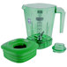 A green Waring blender jar with a green lid.