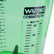 A close up of a green Waring Copolyester blender jar with a black measuring line.