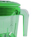 A green Waring blender jar with a green lid and handle.