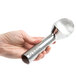 A hand holding a Zeroll aluminum ice cream scoop with a silver cylinder and scoop.