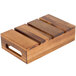 A Tablecraft Fourth Size Acacia Wood Serving and Display Crate with four compartments on a wood surface.