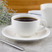 A cup of coffee on a Villeroy & Boch white porcelain saucer.