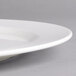 A close-up of a Villeroy & Boch white porcelain flat plate with a thin rim.