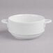 A white Villeroy & Boch porcelain bowl with two handles on a gray surface.