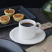 A white Villeroy & Boch porcelain cup of coffee on a plate with pastries.