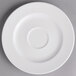 A white porcelain saucer with a circle on it.