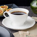 A Villeroy & Boch white porcelain cup of coffee on a plate with pastries.