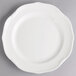 A white Villeroy & Boch porcelain flat plate with a scalloped edge.
