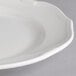 A close up of a white Villeroy & Boch porcelain flat plate with a small rim.