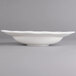 A white porcelain oval deep plate with a curved edge.
