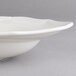 A white Villeroy & Boch porcelain oval deep plate with a wavy rim.