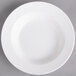 A white Villeroy & Boch porcelain rim deep soup plate on a gray surface.