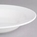 A Villeroy & Boch white porcelain rim deep soup plate on a gray surface.